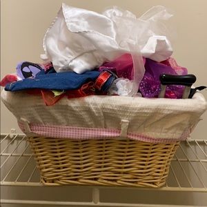 A basket of build-a-bear clothes and accessories